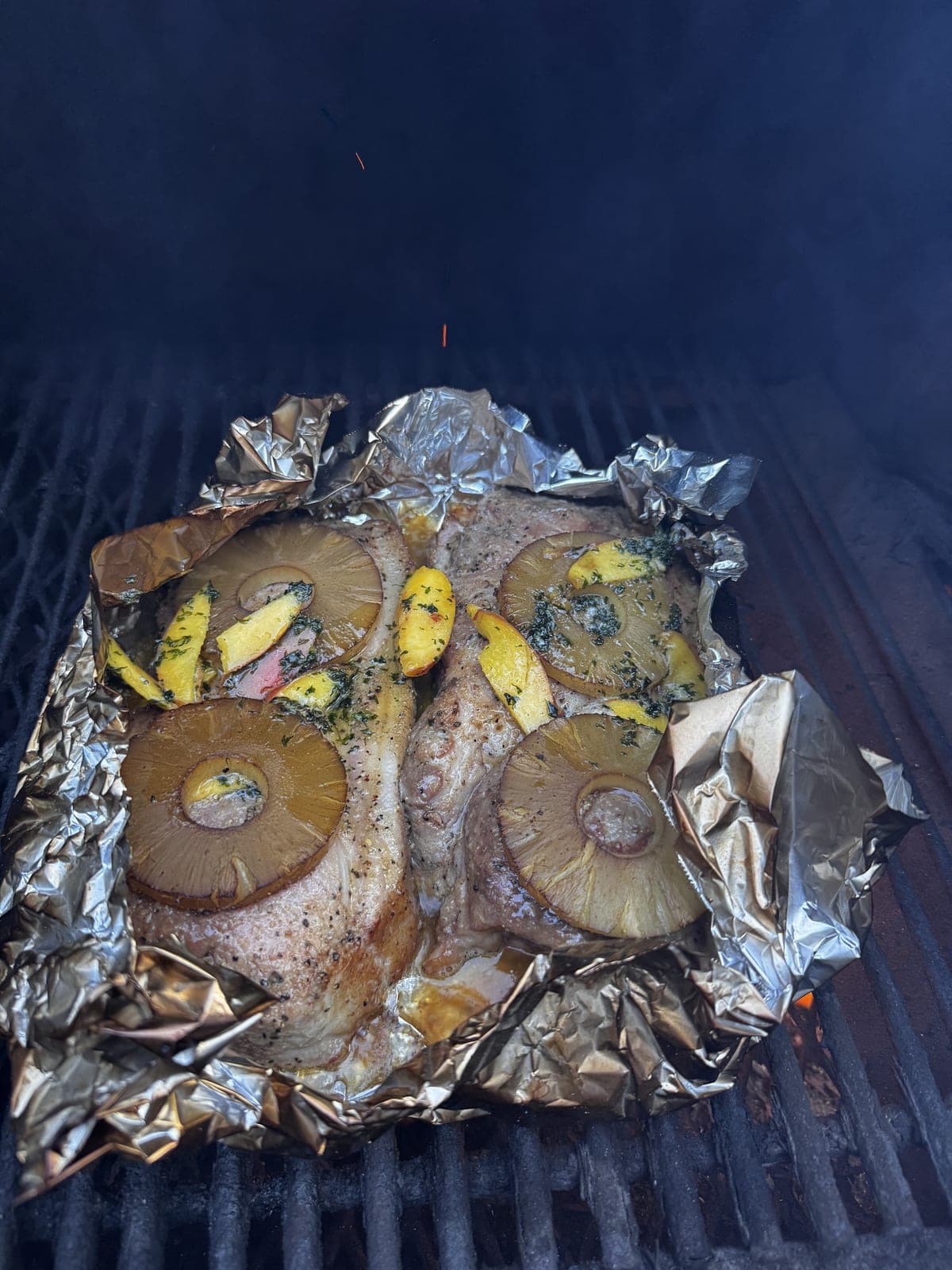 Grilled fish with pineapple rings on the smoker